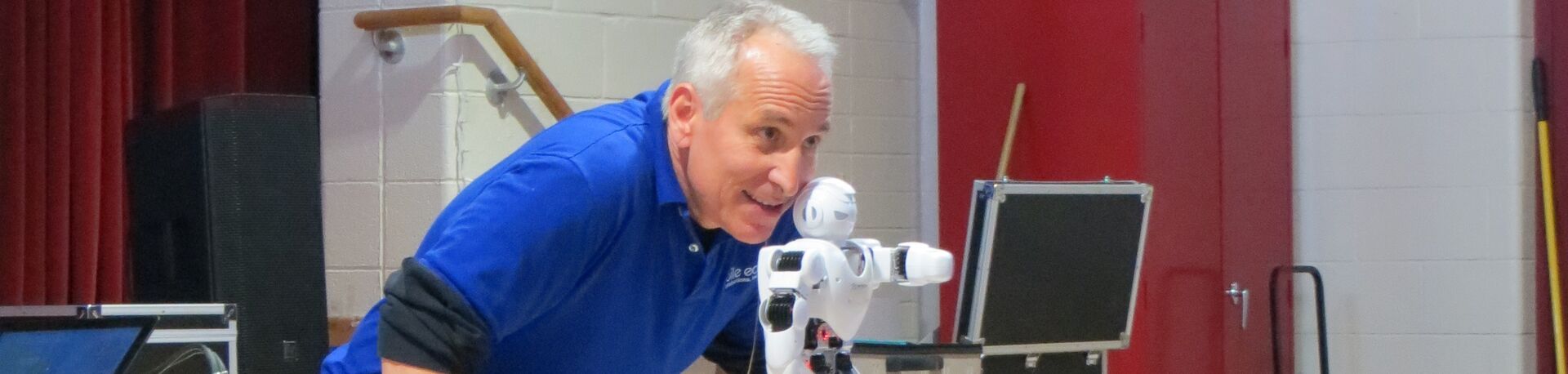 Performer with robot at school assembly